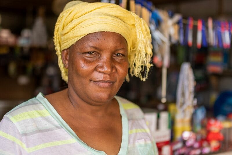 African woman in front of market stall