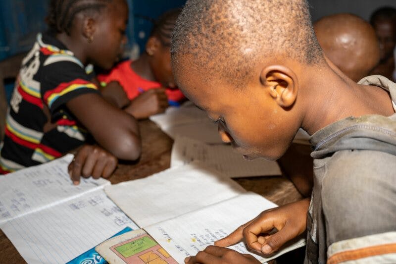 African children studying from notebooks